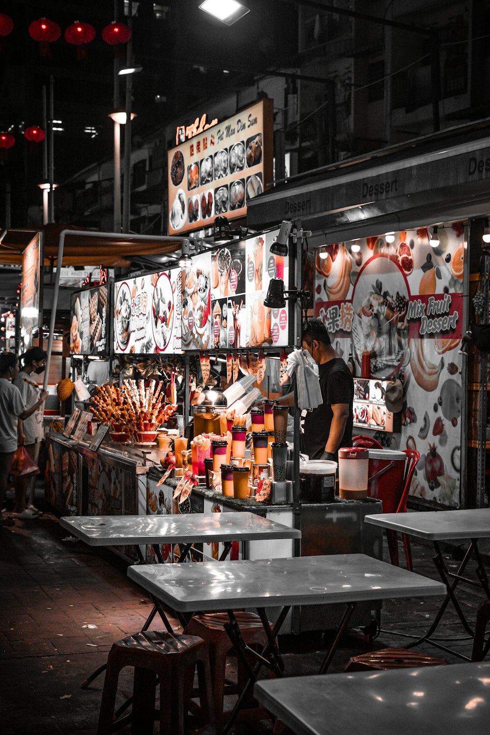 a man standing in front of a food stand