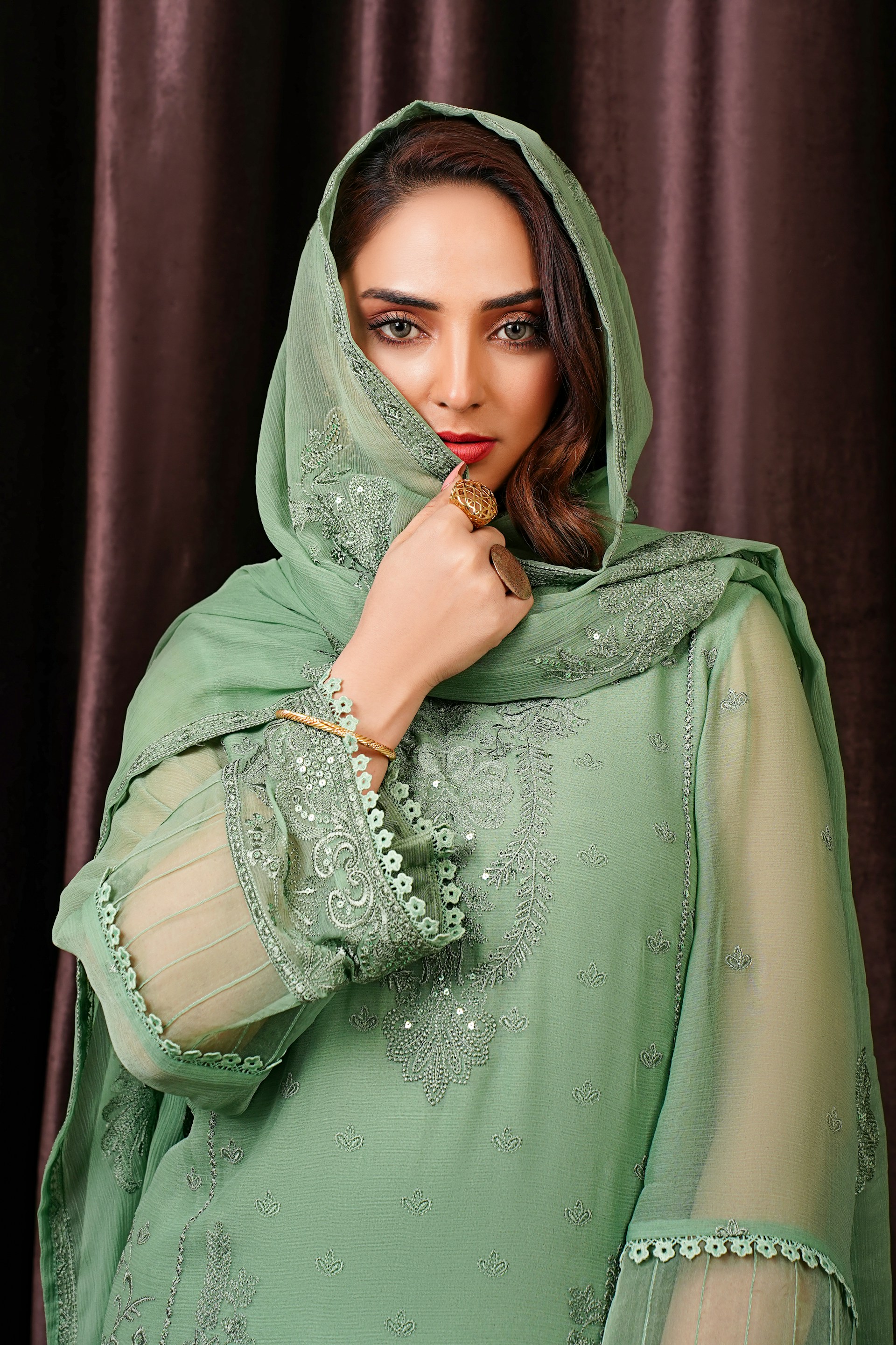 a woman in a green dress posing for a picture