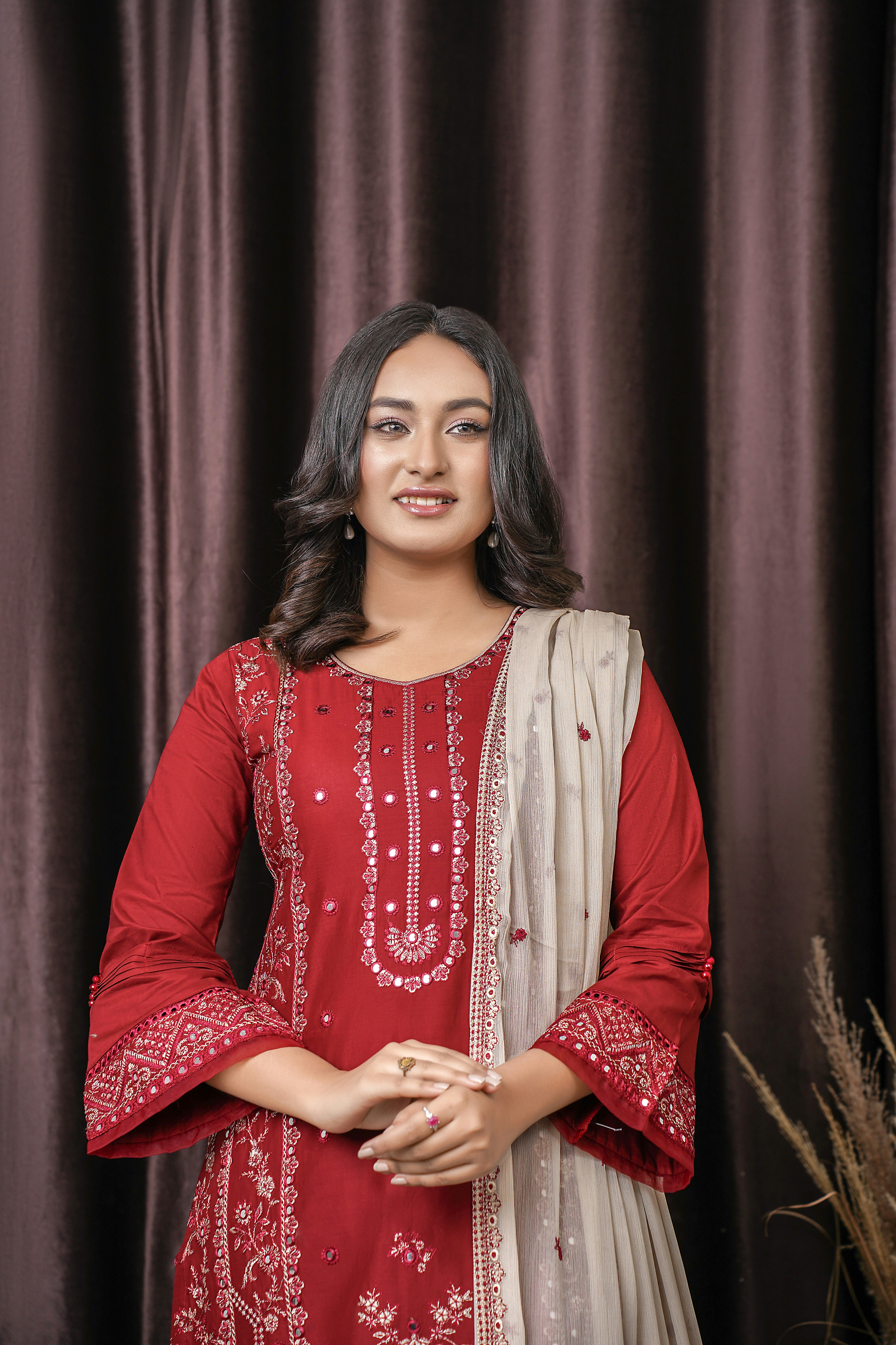 a woman standing in front of a curtain