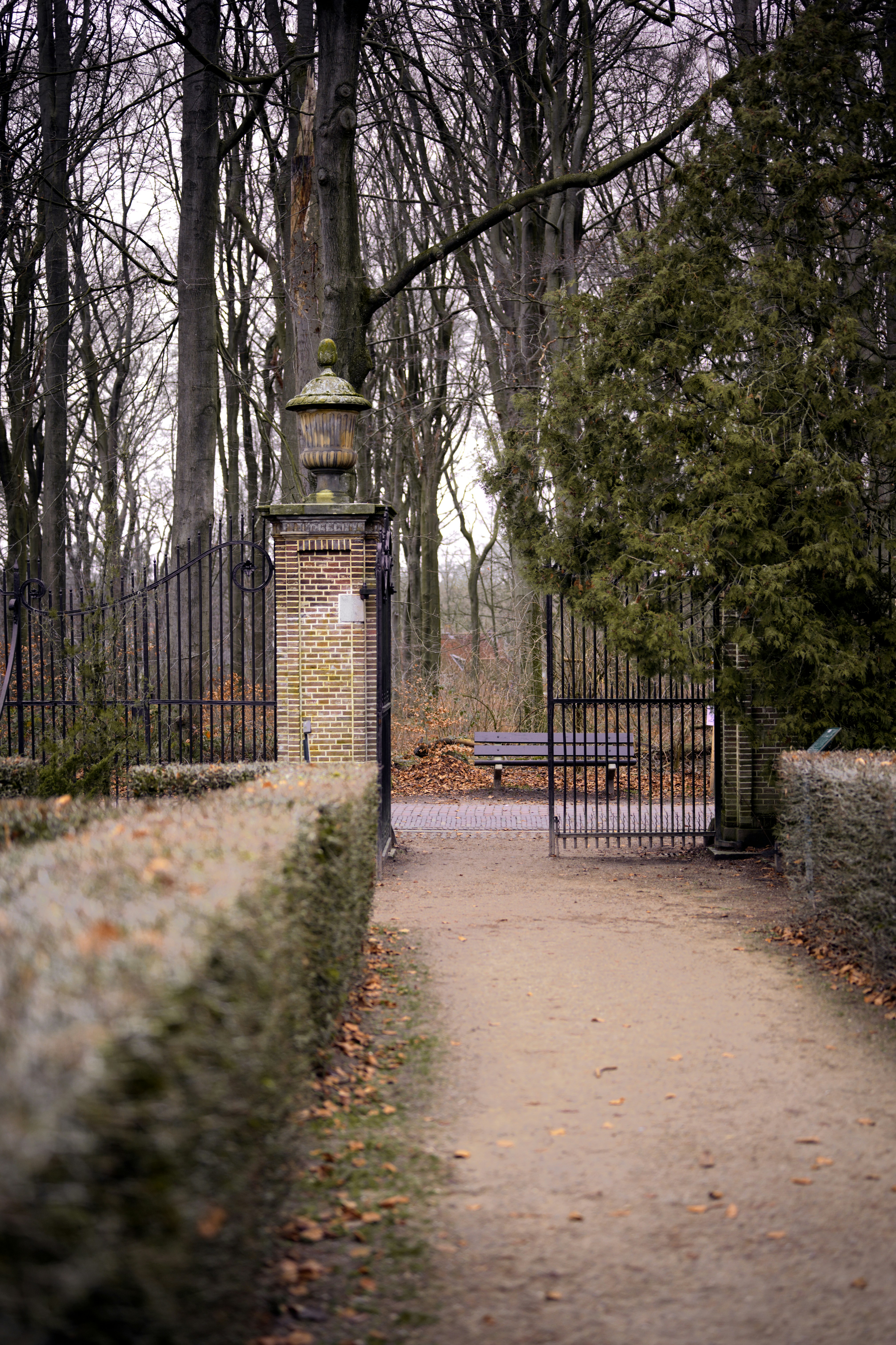 a stone gate with a clock on top of it