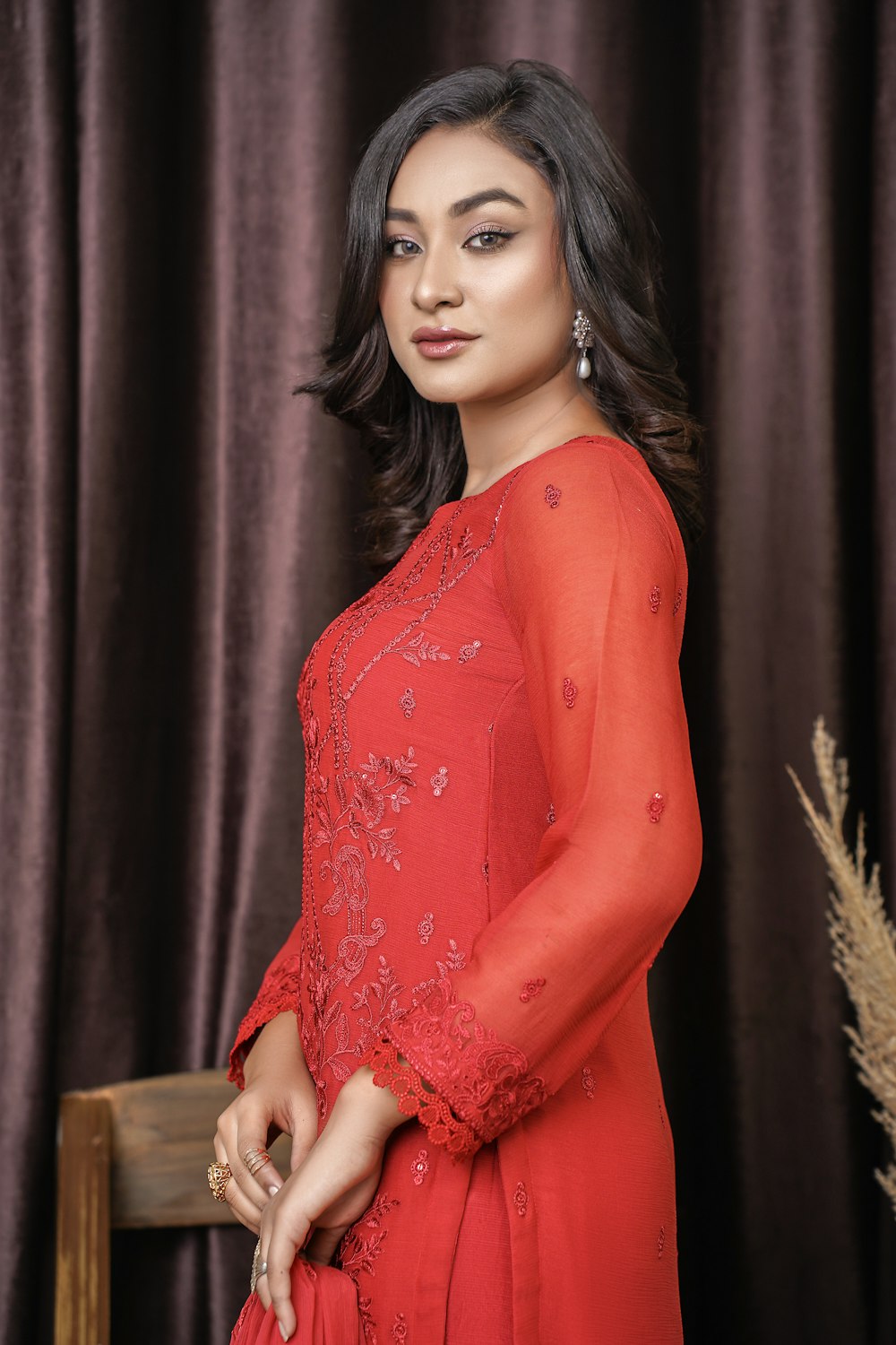 a woman in a red dress posing for a picture