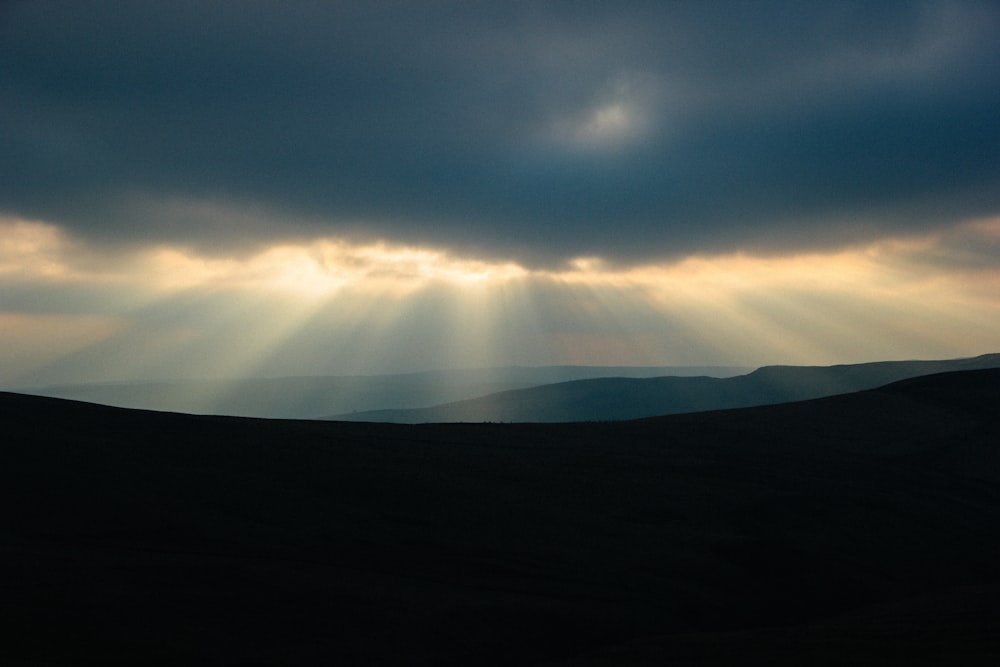 the sun is shining through the clouds in the sky