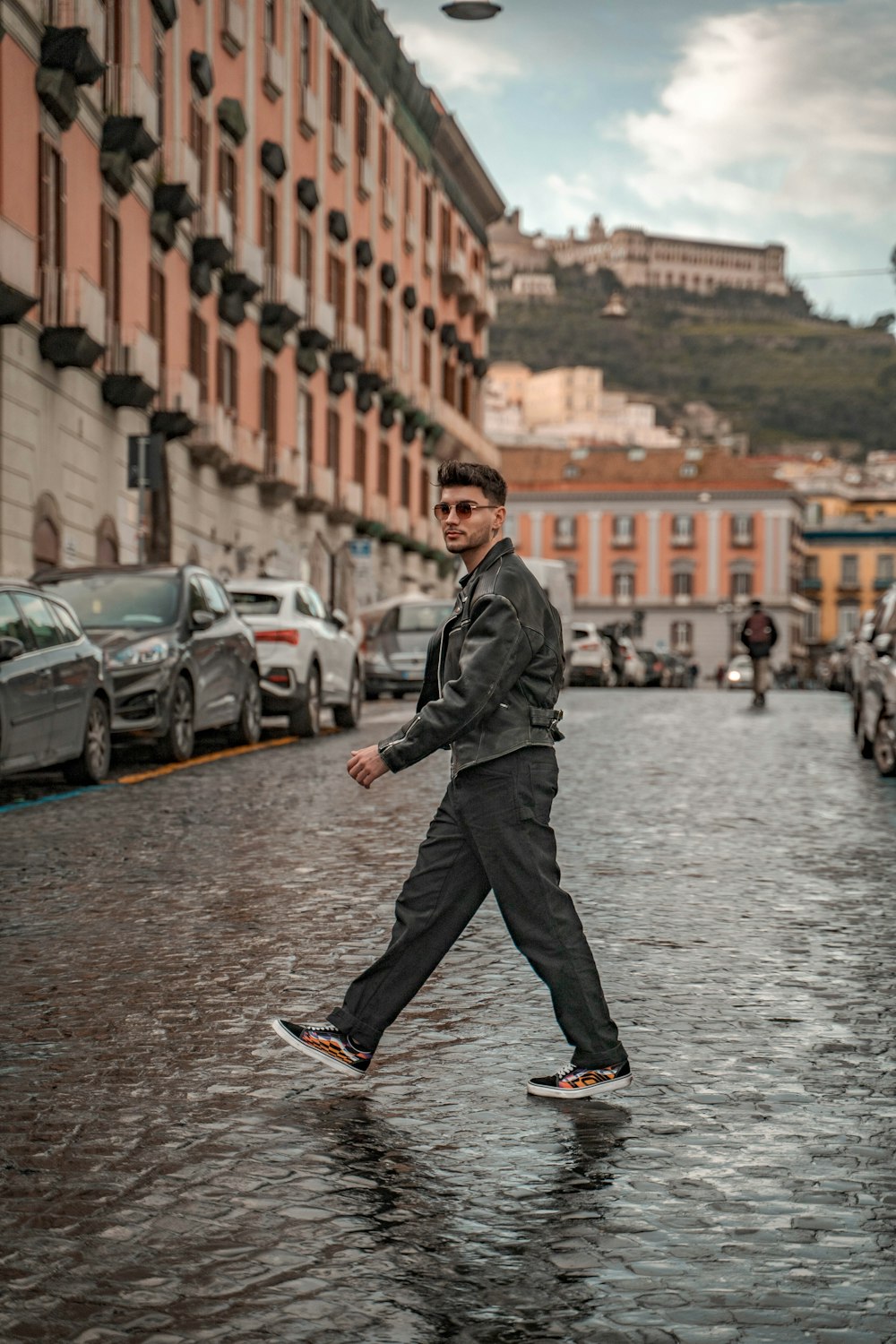 a man walking down a street in the rain