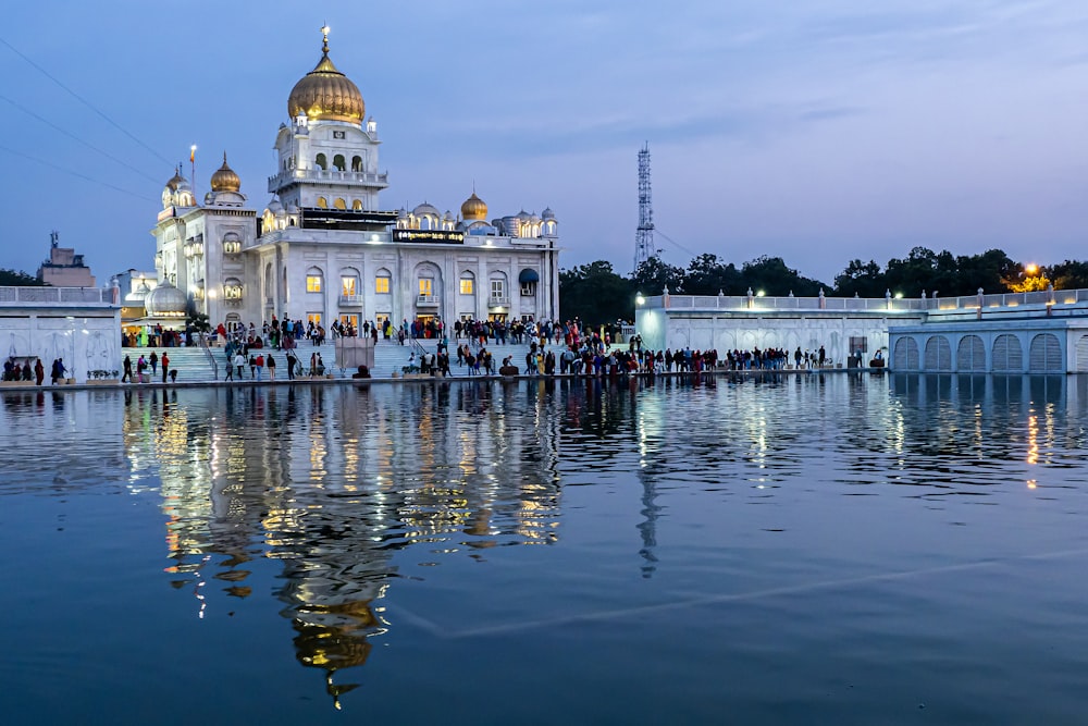 a large white building sitting on top of a lake