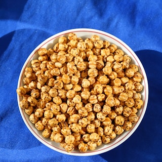 a bowl of popcorn on a blue cloth