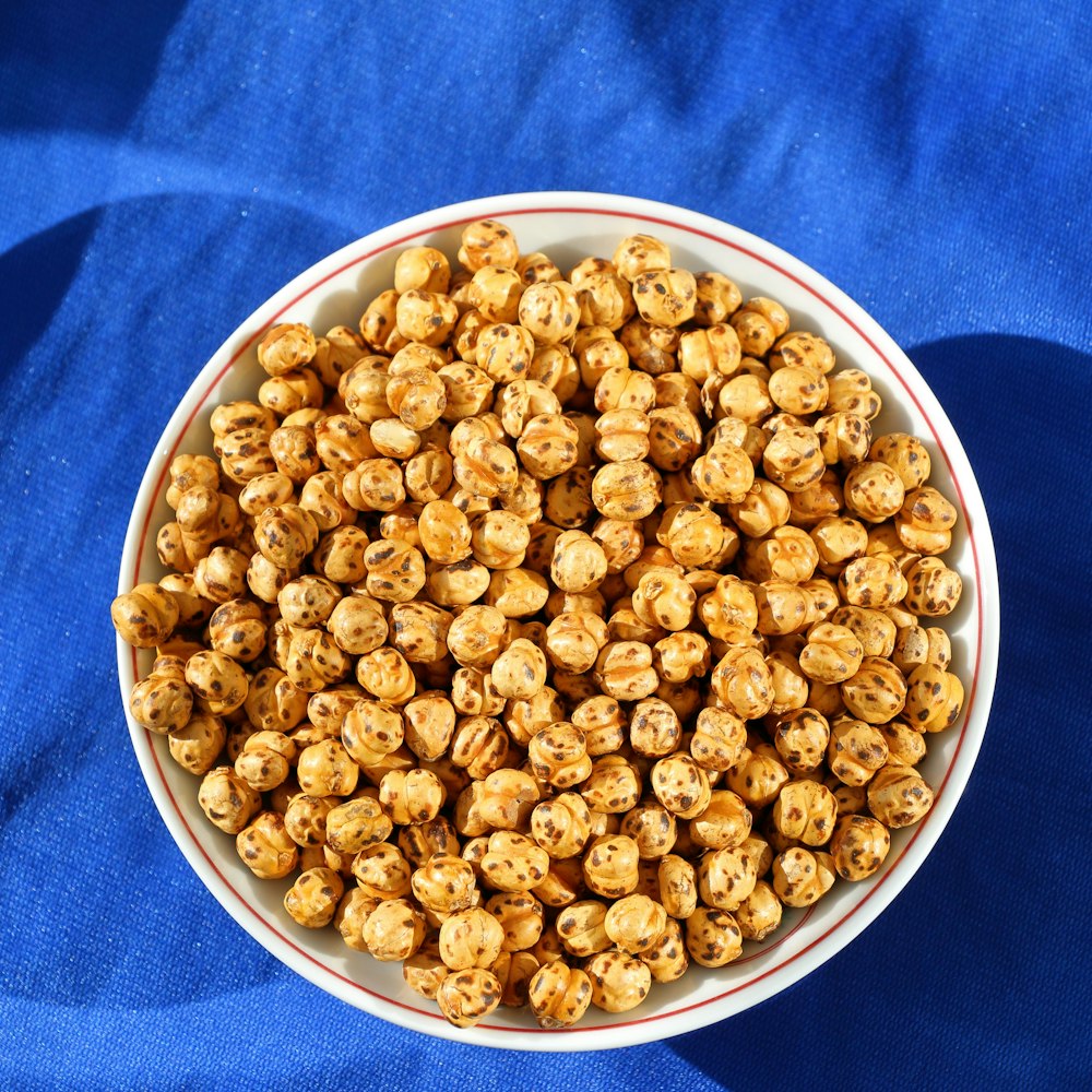 a bowl of popcorn on a blue cloth