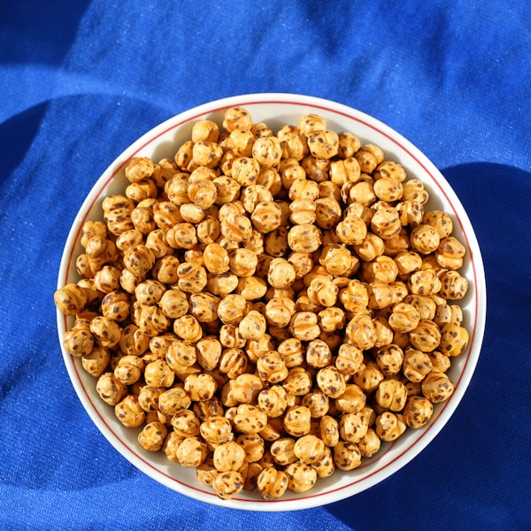 A bowl of popcorn on a blue cloth