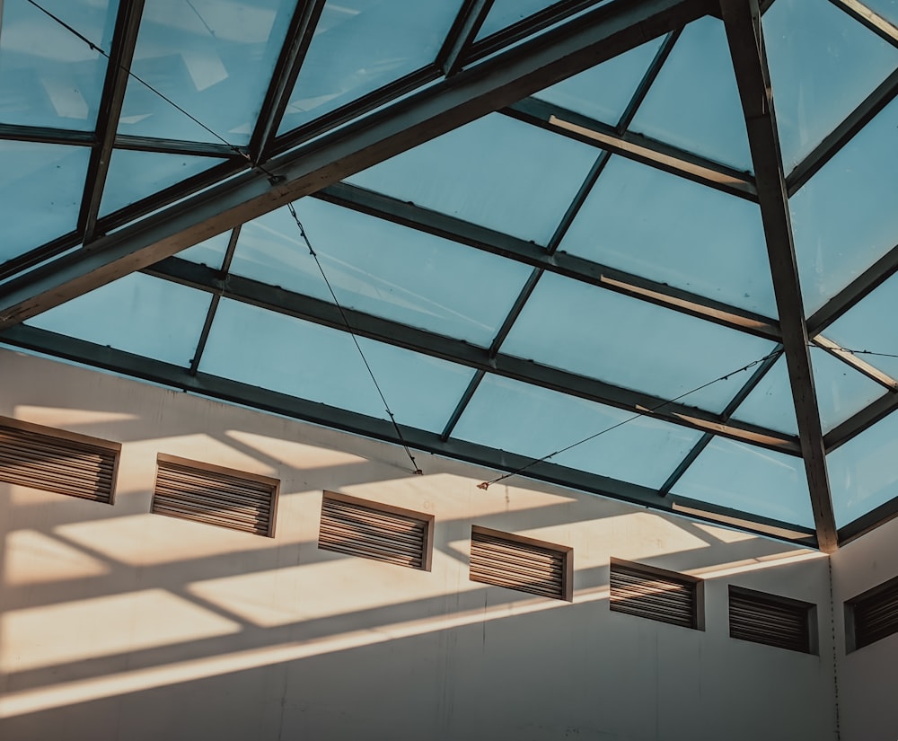 a room with a glass roof and several windows