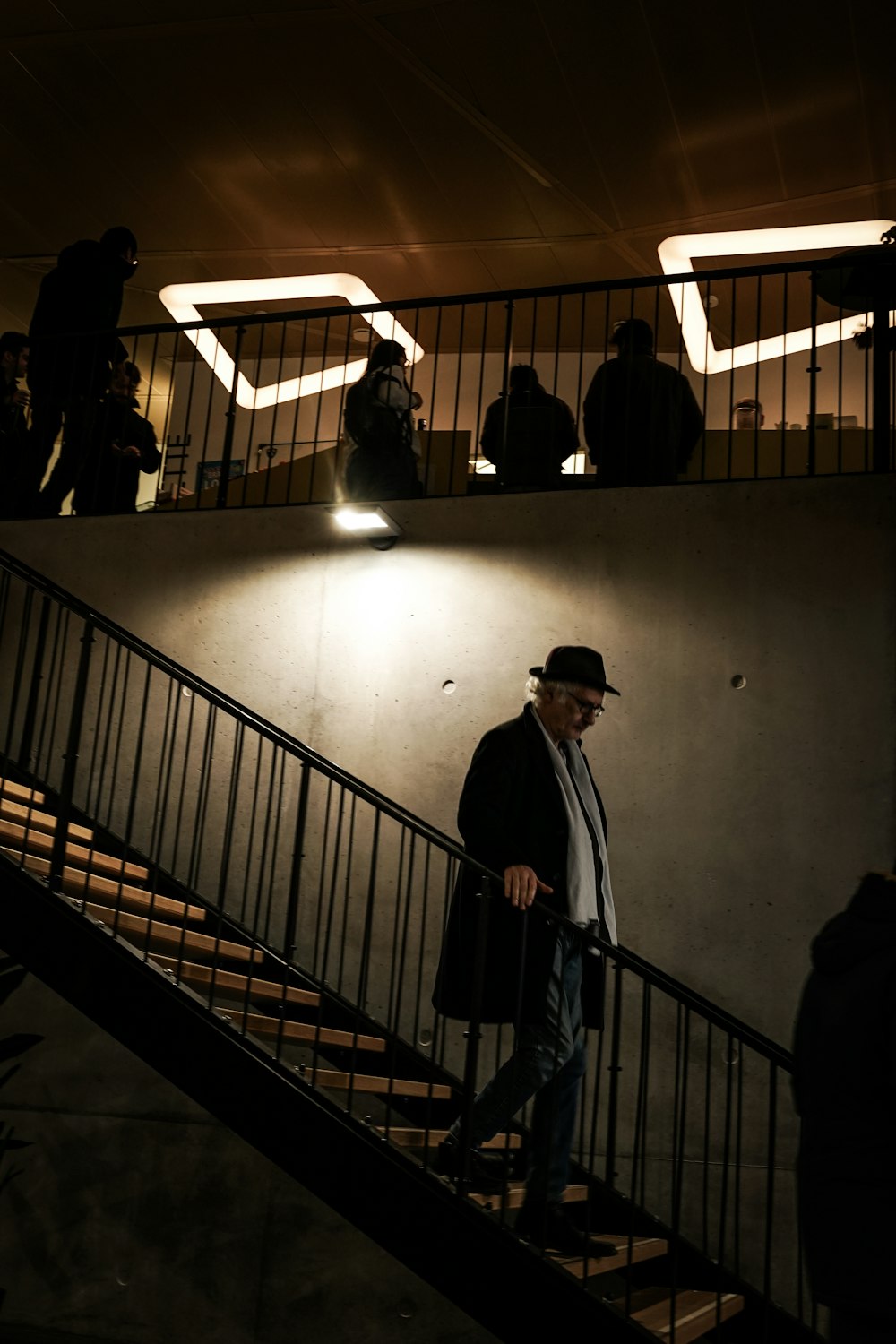 a man walking up a flight of stairs at night