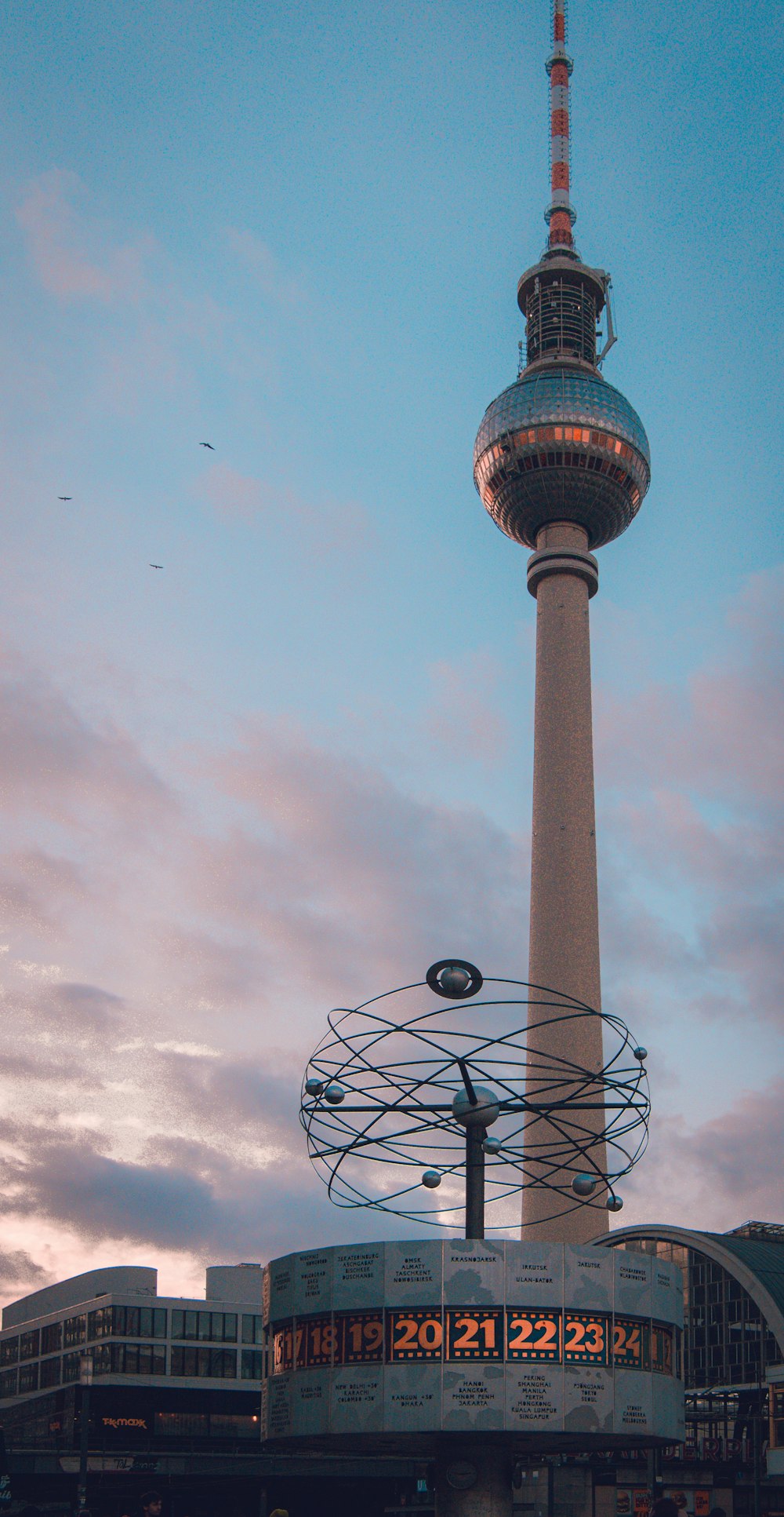 a very tall tower with a clock on it's side