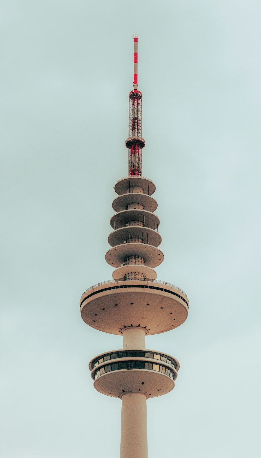 a tall tower with a red and white top