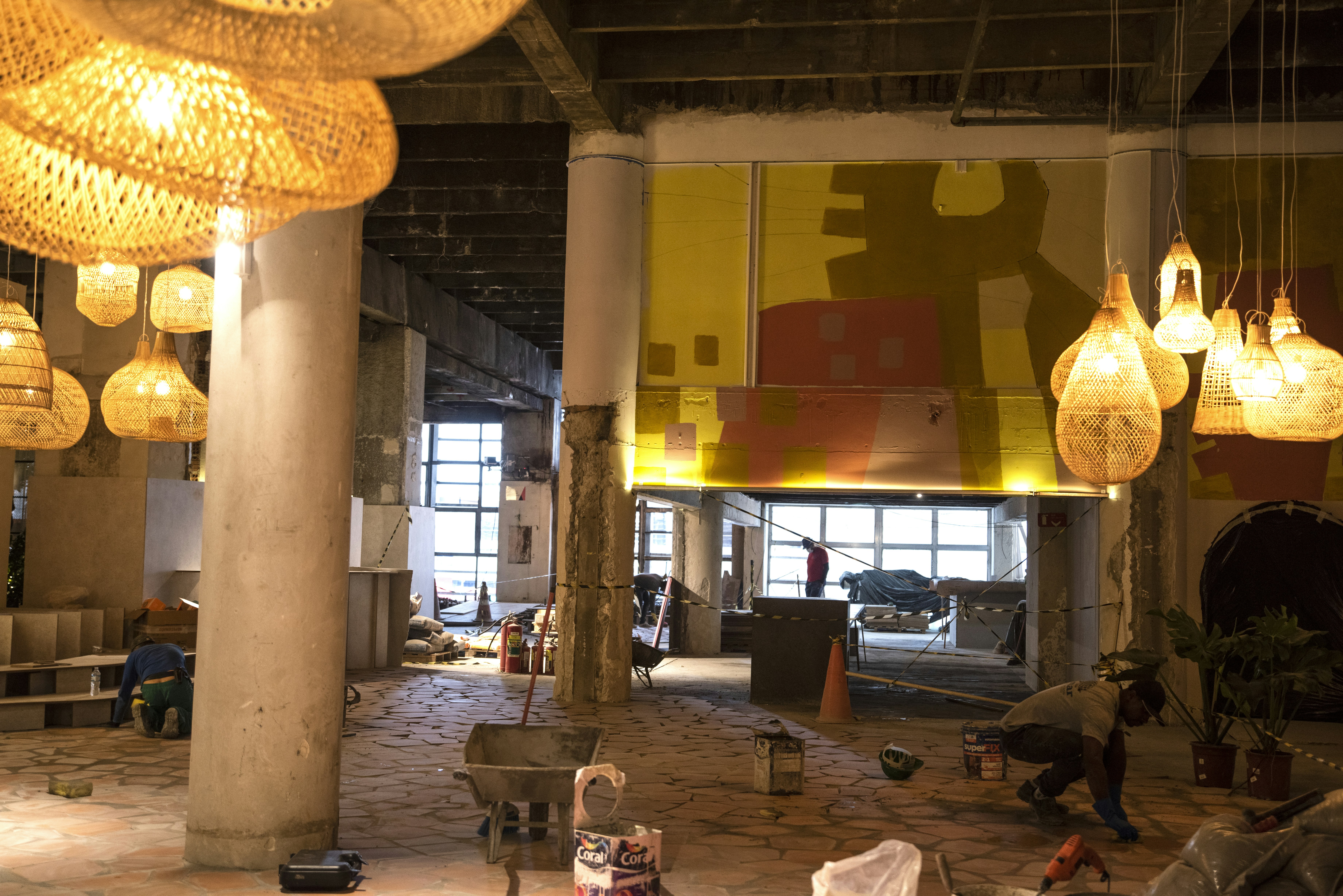 a large room with a lot of lights hanging from the ceiling