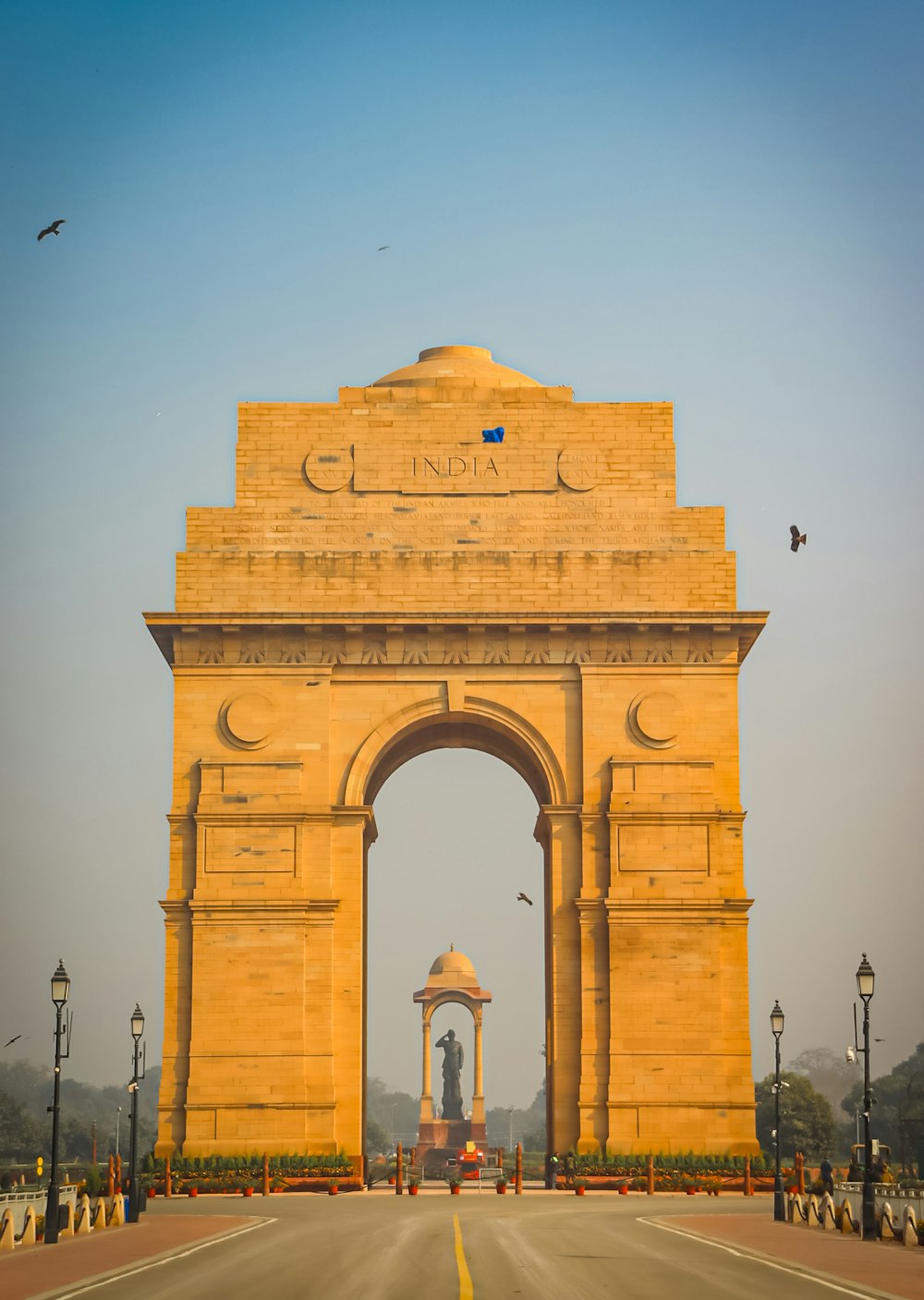 a large arch with a statue on top of it