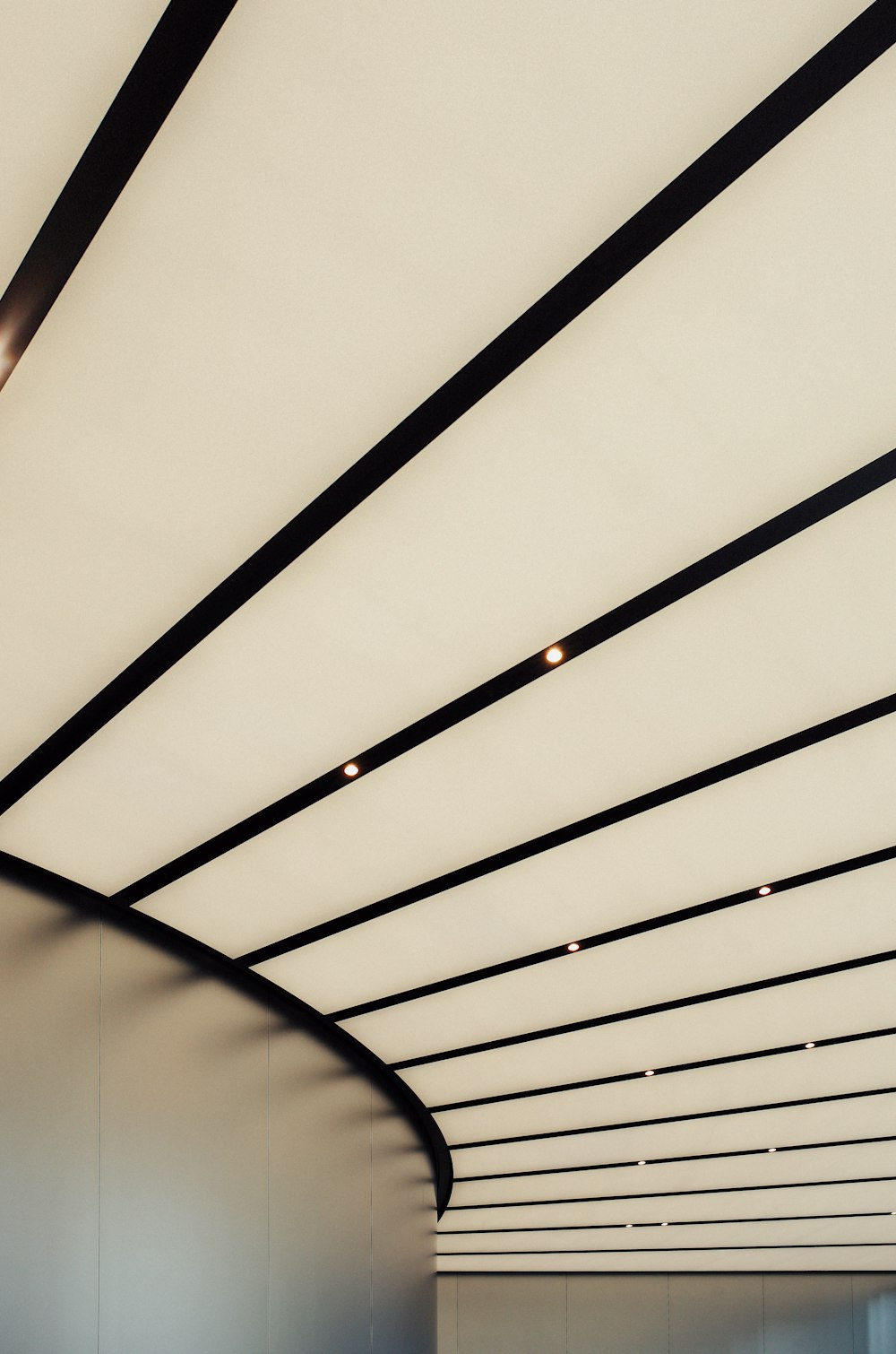 a white room with a curved ceiling and a clock on the wall