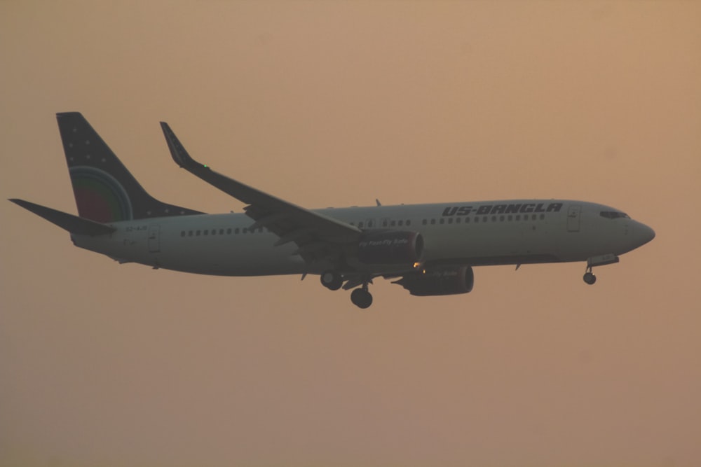 a large jetliner flying through a foggy sky