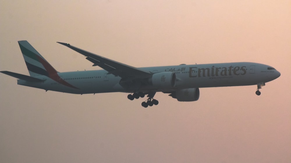 a large jetliner flying through a cloudy sky