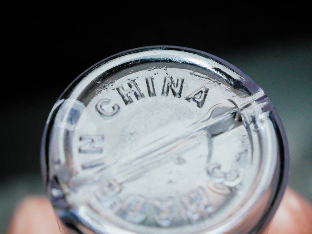 a close up of a person holding a small bottle