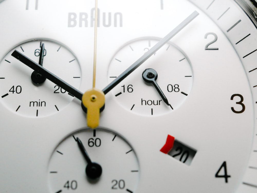 a close up of a white watch face