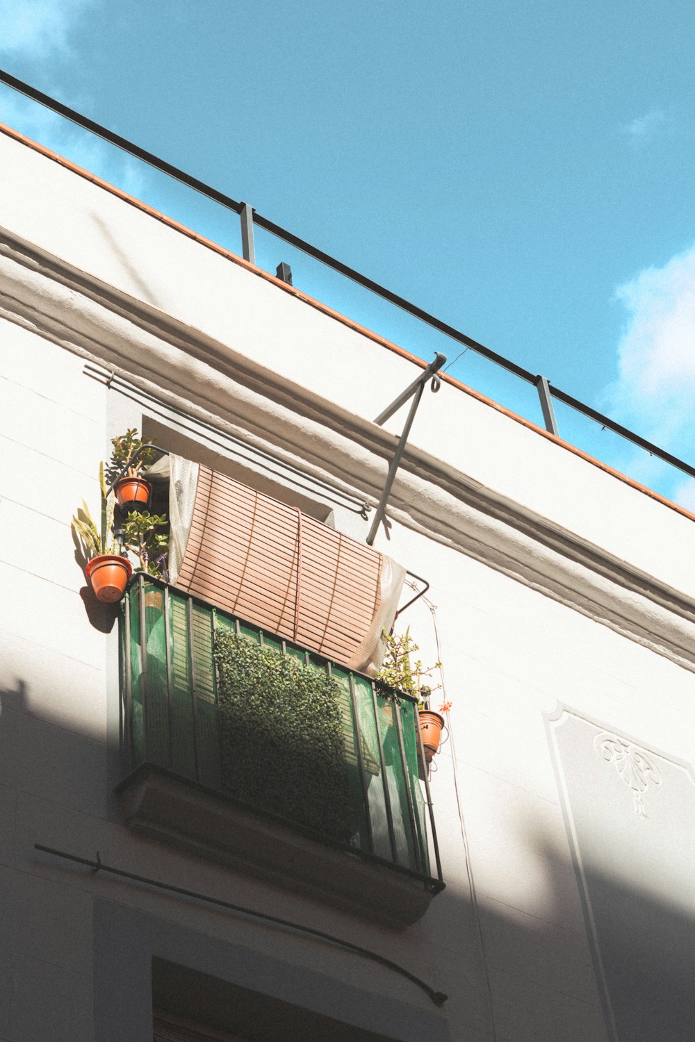 a building with a window and a planter on it