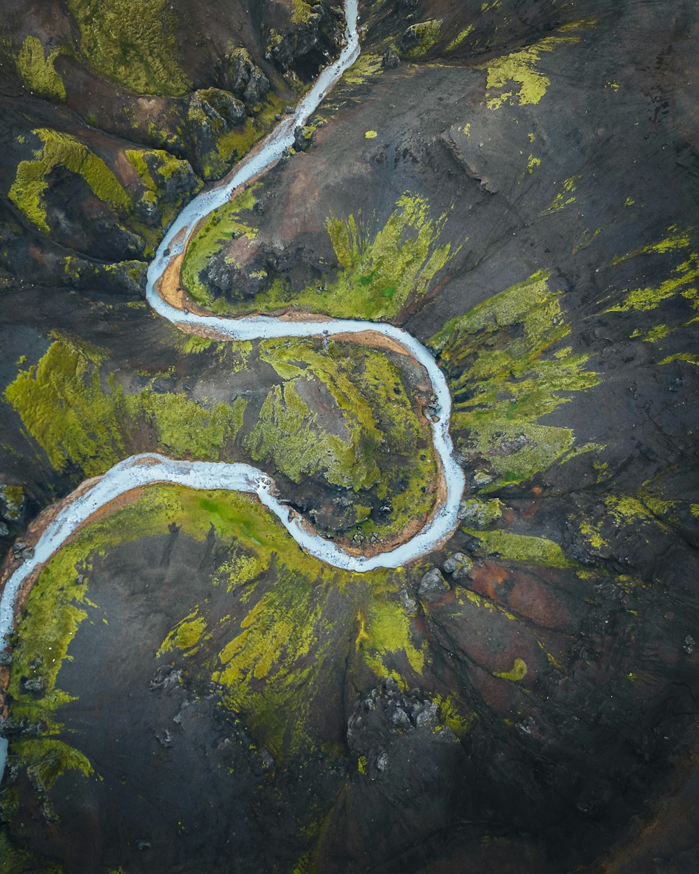 a river running through a lush green valley