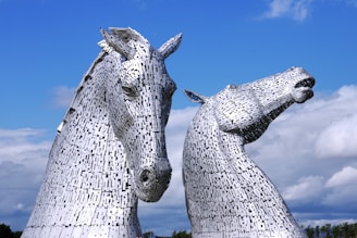 two large metal horses standing next to each other