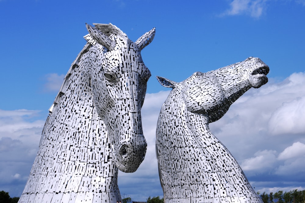 two large metal horses standing next to each other