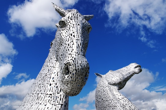 a couple of statues of horses standing next to each other