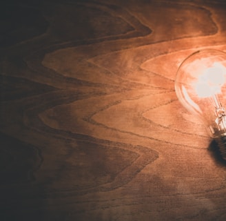 a light bulb sitting on top of a wooden table