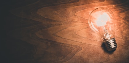 a light bulb sitting on top of a wooden table