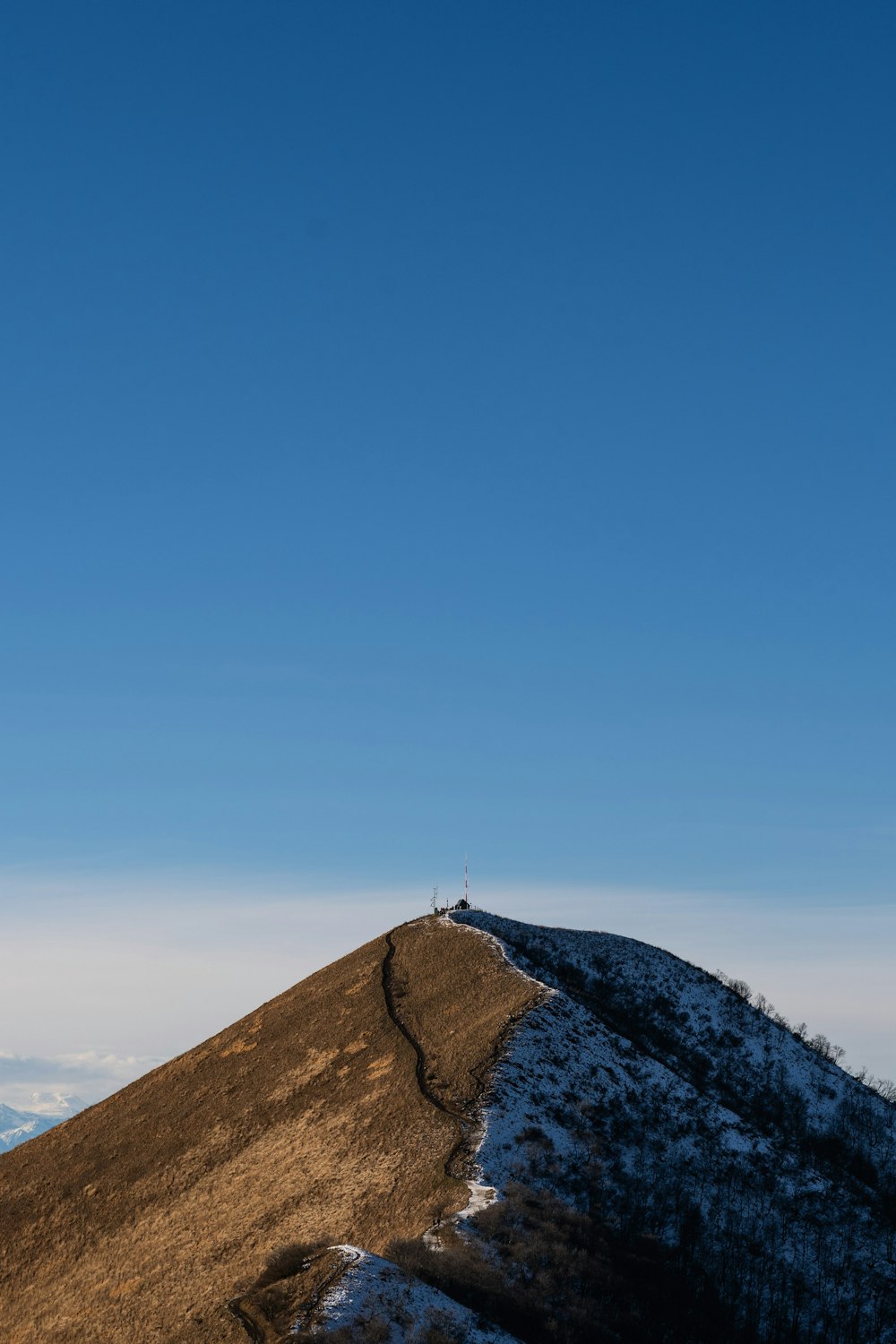 a person standing on top of a snow covered hill