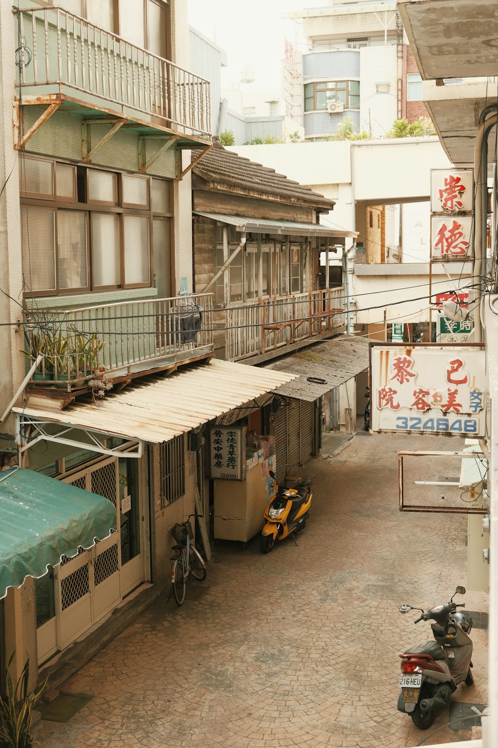 an alley way with a scooter parked in front of a building