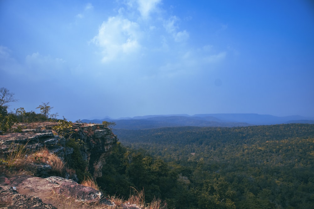 a scenic view of a mountain with a blue sky