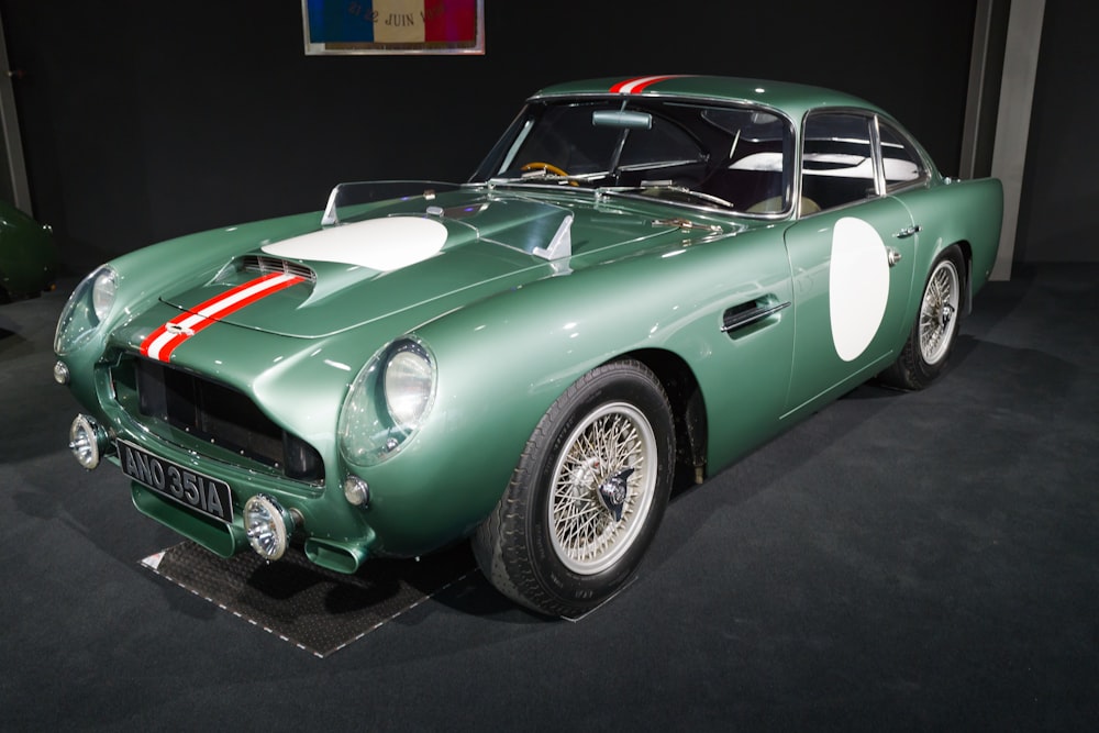 a green sports car on display in a museum