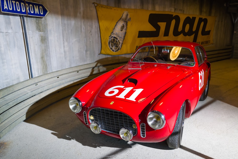 a red sports car parked in a garage