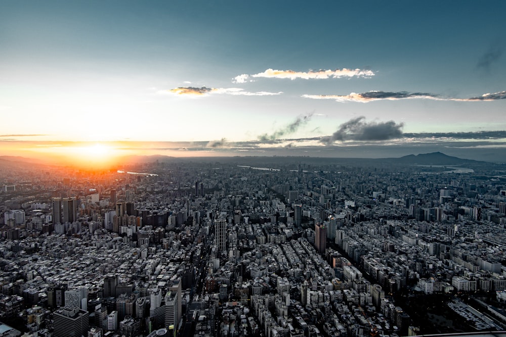 the sun is setting over a large city