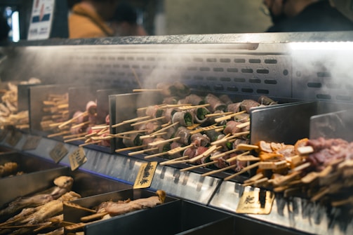 a bunch of food is being cooked on a grill