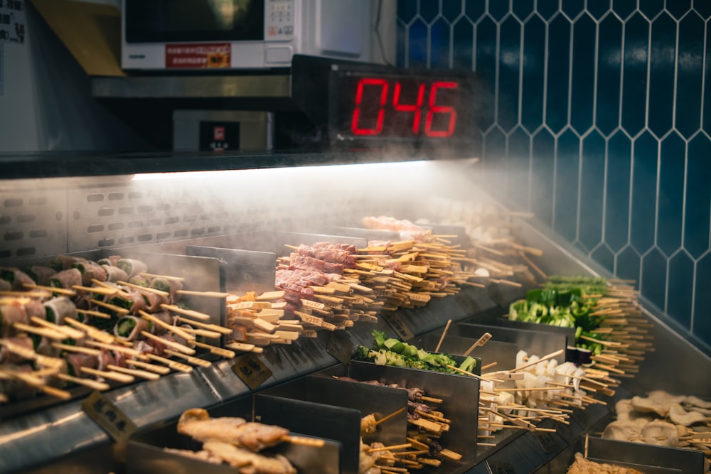 a large number of food is being prepared on a grill