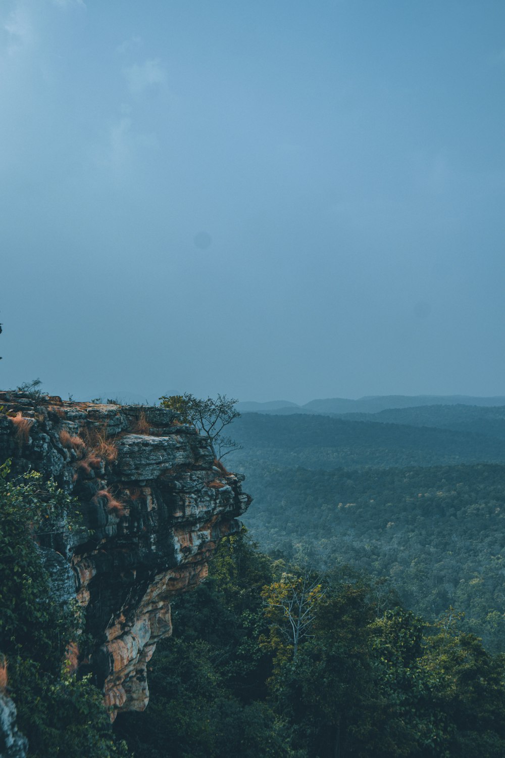 a person standing on top of a cliff