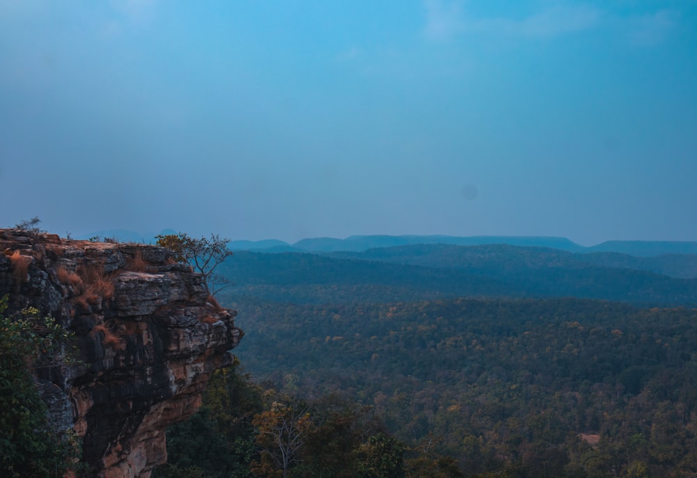 a view of the mountains from the top of a cliff