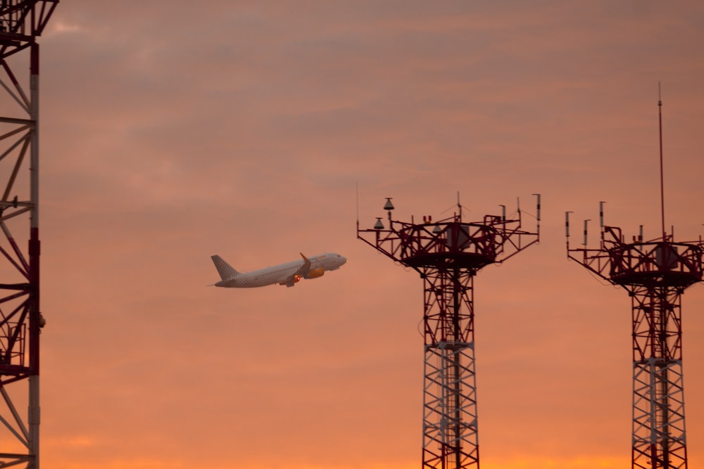 a plane is flying low over a tower