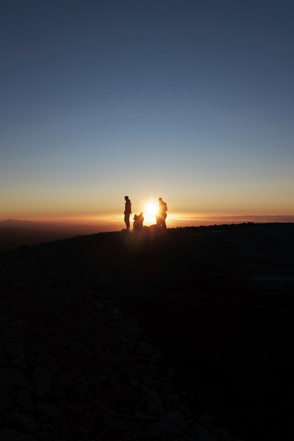 a couple of people standing on top of a hill