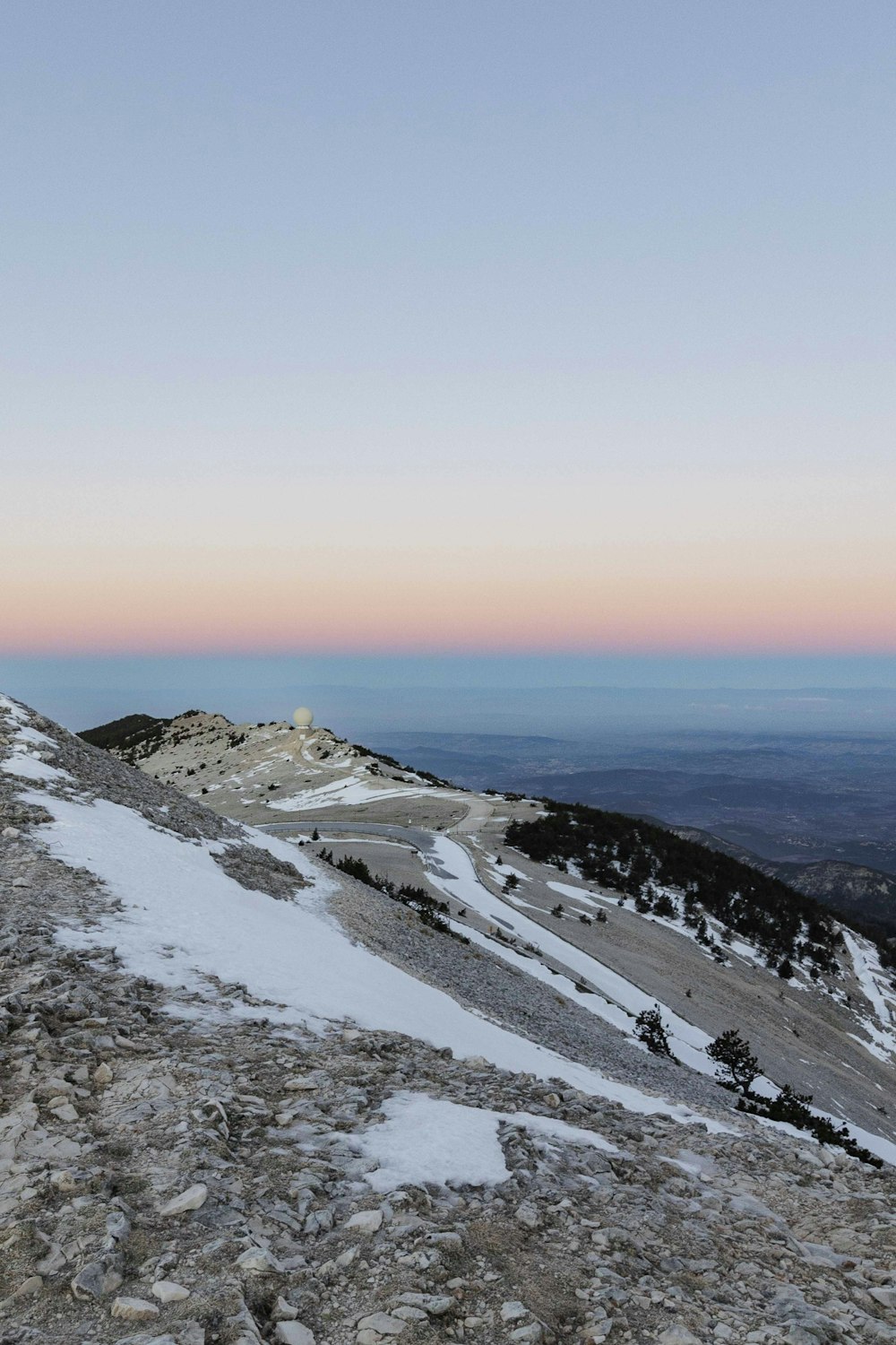 a man standing on top of a snow covered mountain