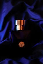 a bottle of perfume sitting on top of a blue cloth