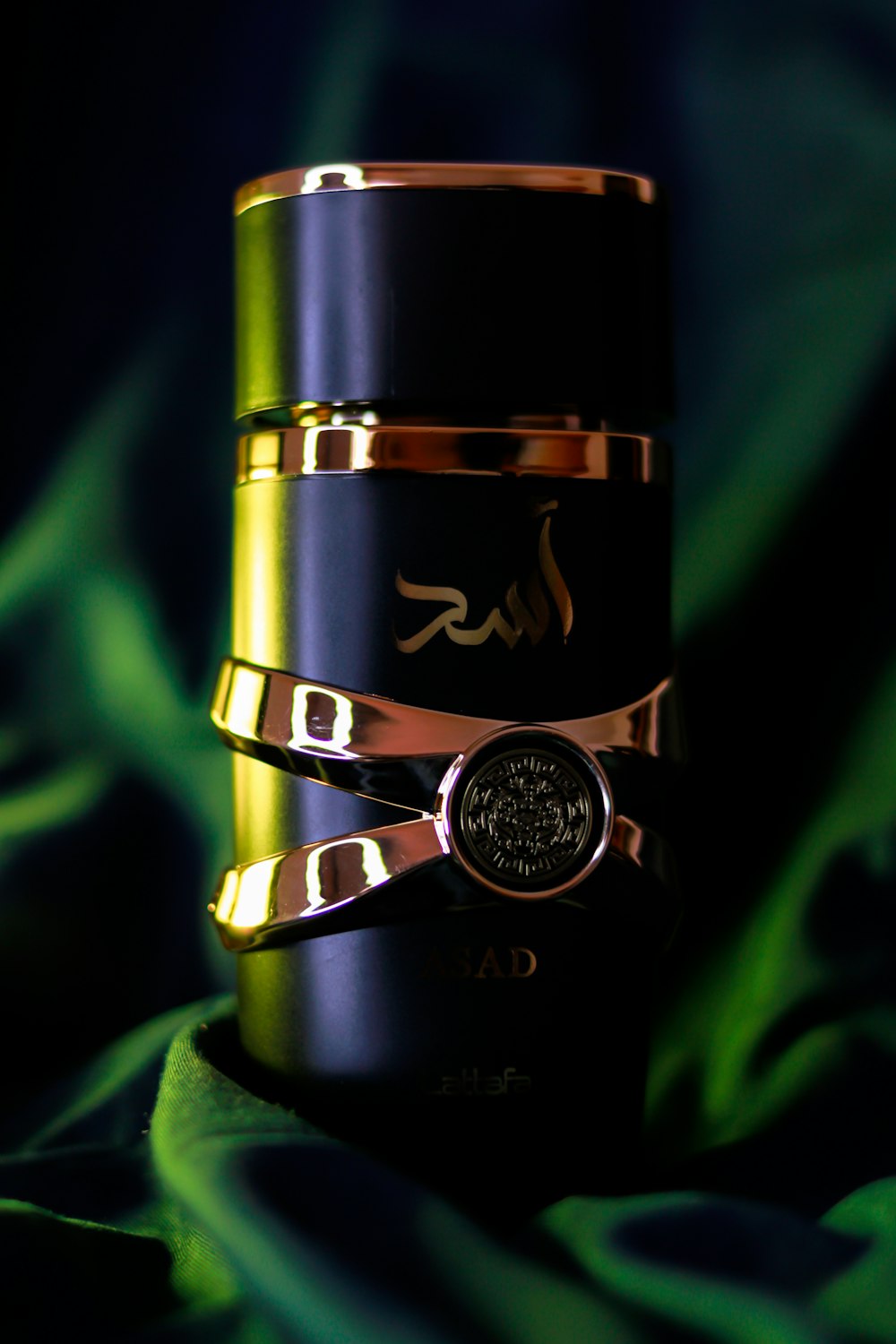 a gold and black stack of rings on a green cloth
