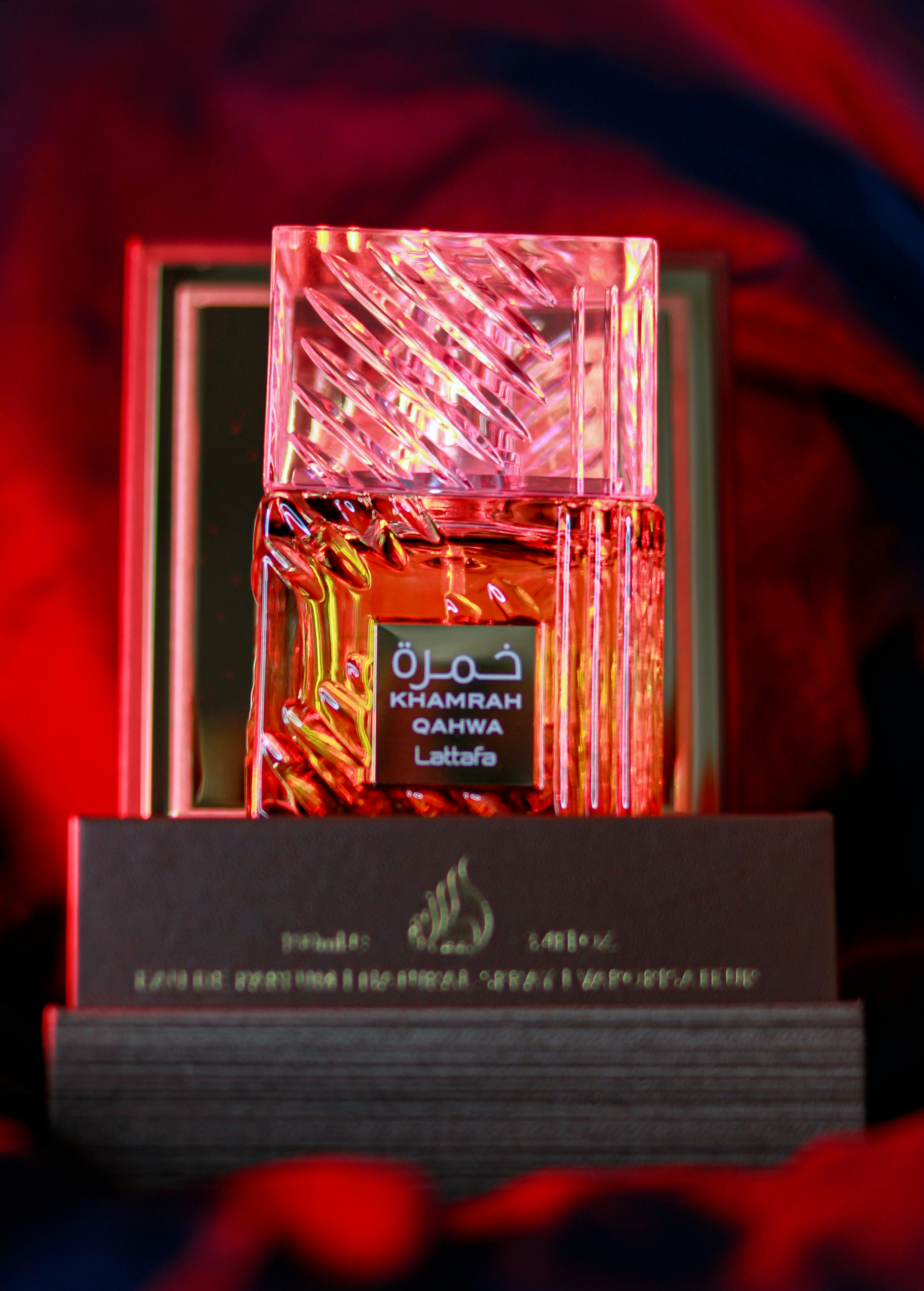 Luxury perfume bottle with amber liquid, warm atmospheric lighting on dark background