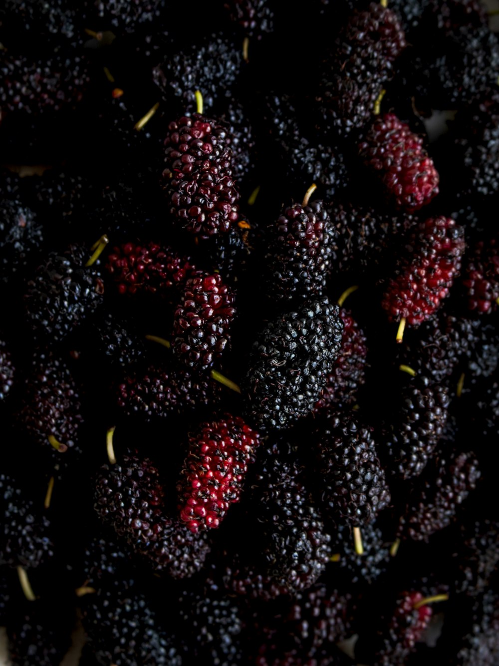 a pile of black raspberries sitting on top of a table