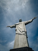 a large statue of jesus on top of a hill