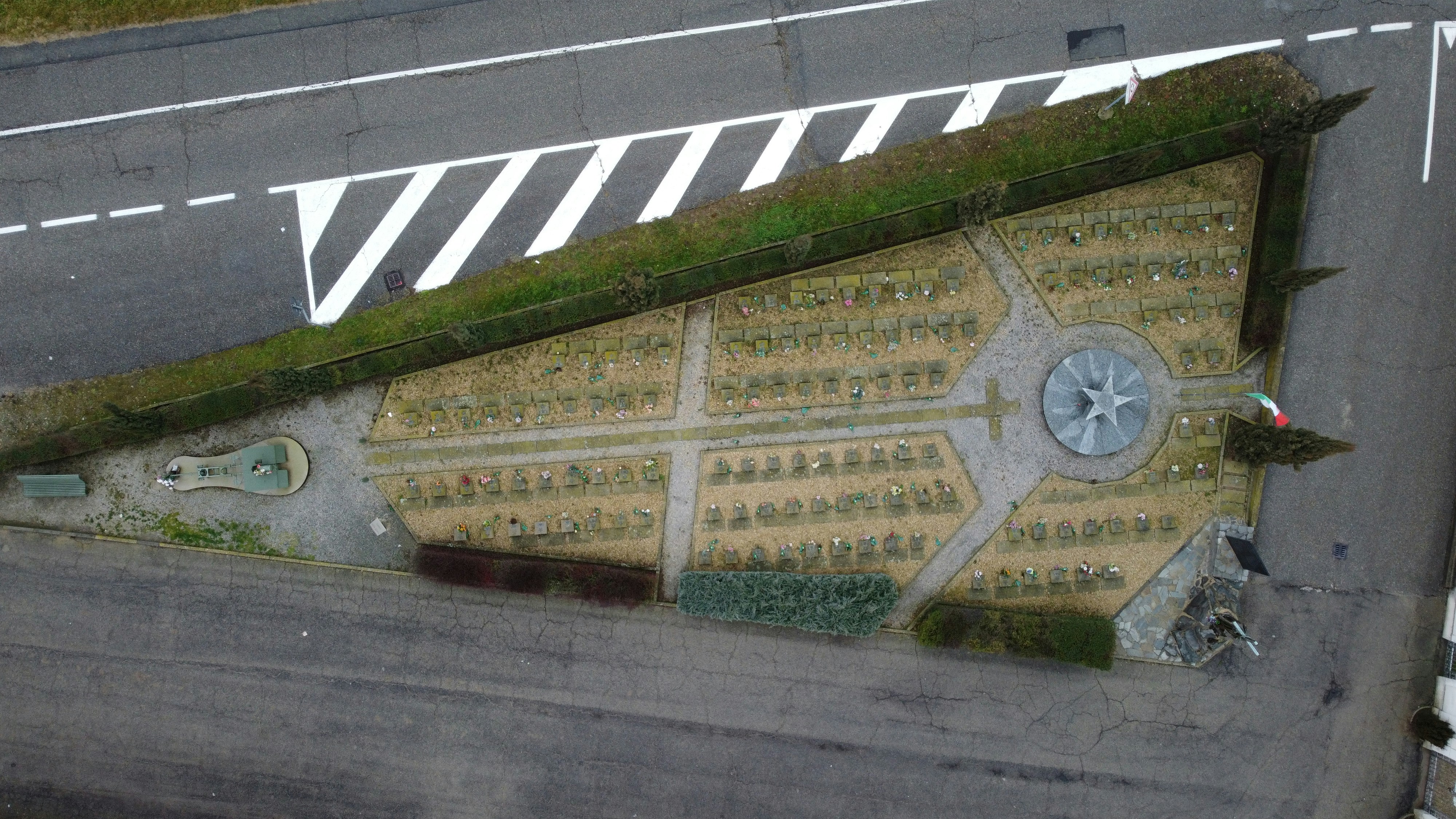 an aerial view of a parking lot with grass growing on it