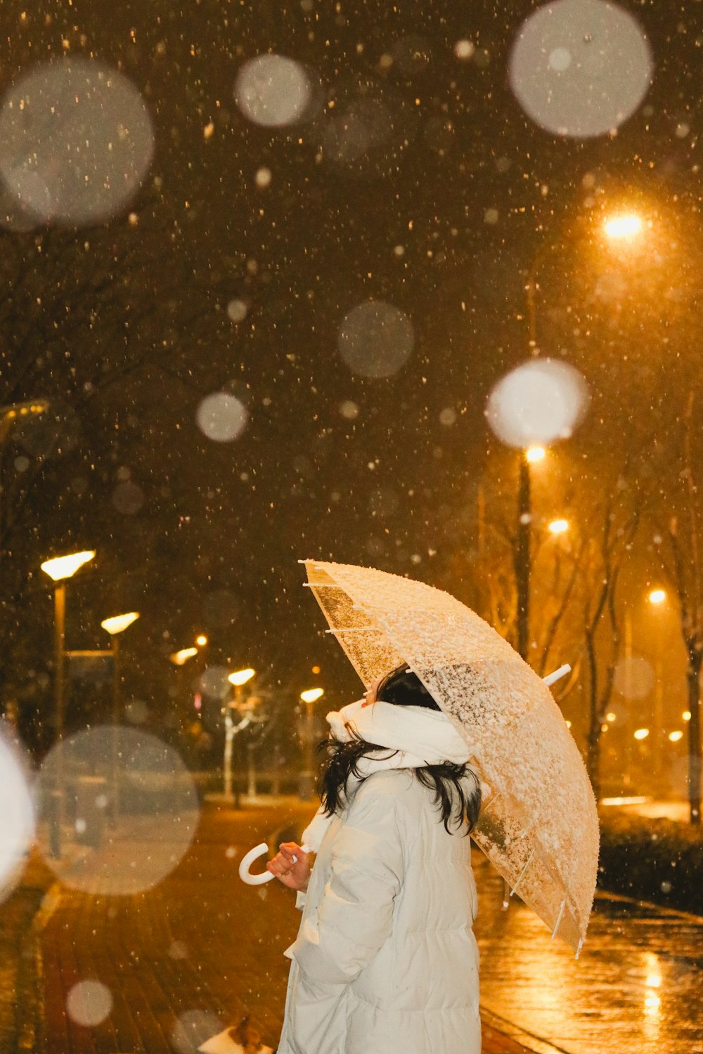 a woman walking down a street holding an umbrella