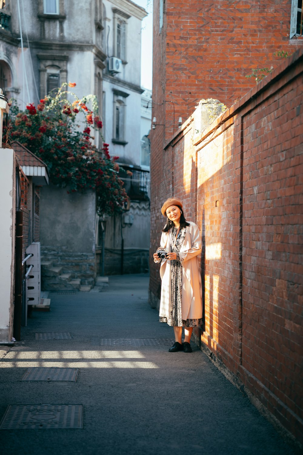 a woman leaning against a brick wall